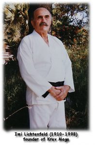 A picture of Imi Lichtenfeld, the founder of Krav Maga standing in a white gi with a black belt