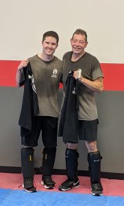 A picture of two students who have just finished their grueling black shirt test