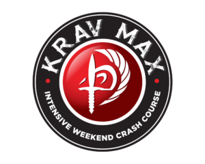 A picture of the Krav Max logo showing the winged dagger entwined with the Hebrew Krav Maga symbol. It's surrounded by the words Krav Max, weekend crash course.